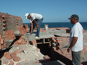 Our builder (right) supervises work on what is the ground floor near a bathroom.
