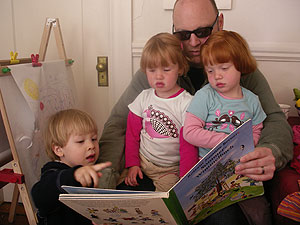 If we're fortunate, Calvin will realize just how lucky he was to hang out with two of the cutest girls around! Here they're all enjoying a German children's book! Lots more fun was had racing pushcars up and down the corridor, and even taking turns!